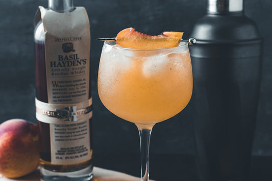 Fall Peach Bourbon Drink in a tall wine glass