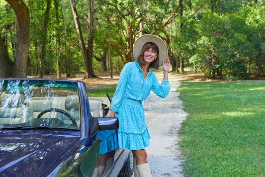 Woman wearing dress walking by lake