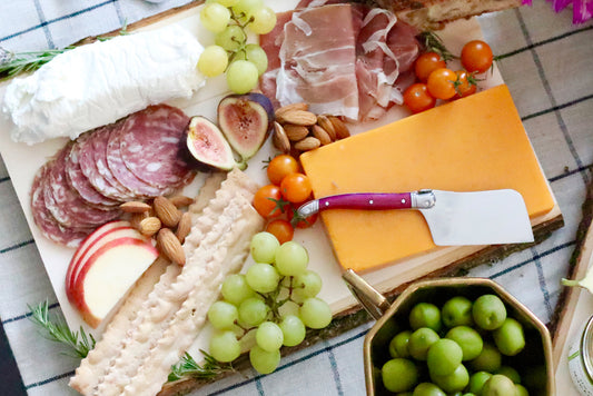 Charcuterie Board with grapes, crackers, and figs