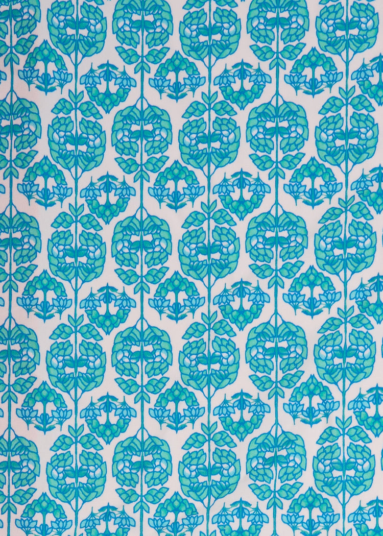 A close up of the UPF 50+ green and blue printed fabric on the Cabana Life Rosebay Embroidered Tankini Top.