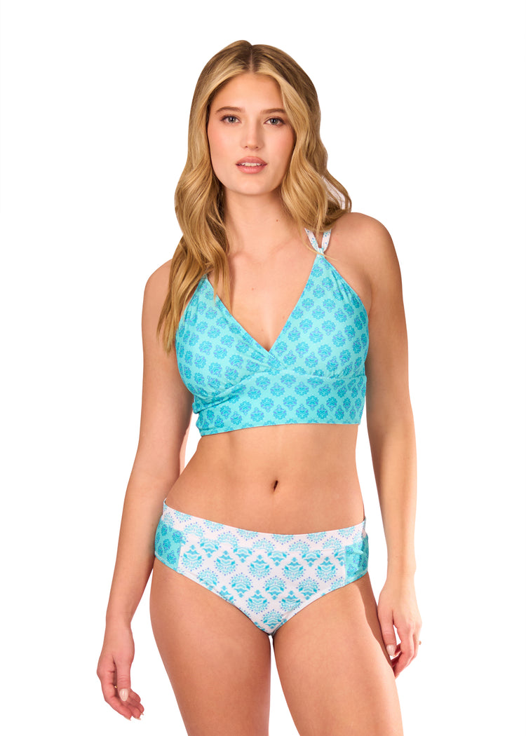 Blonde woman wearing Amalfi Coast Reversible Bikini Top with Amalfi Coast Mid Rise Bikini Bottom on white background.