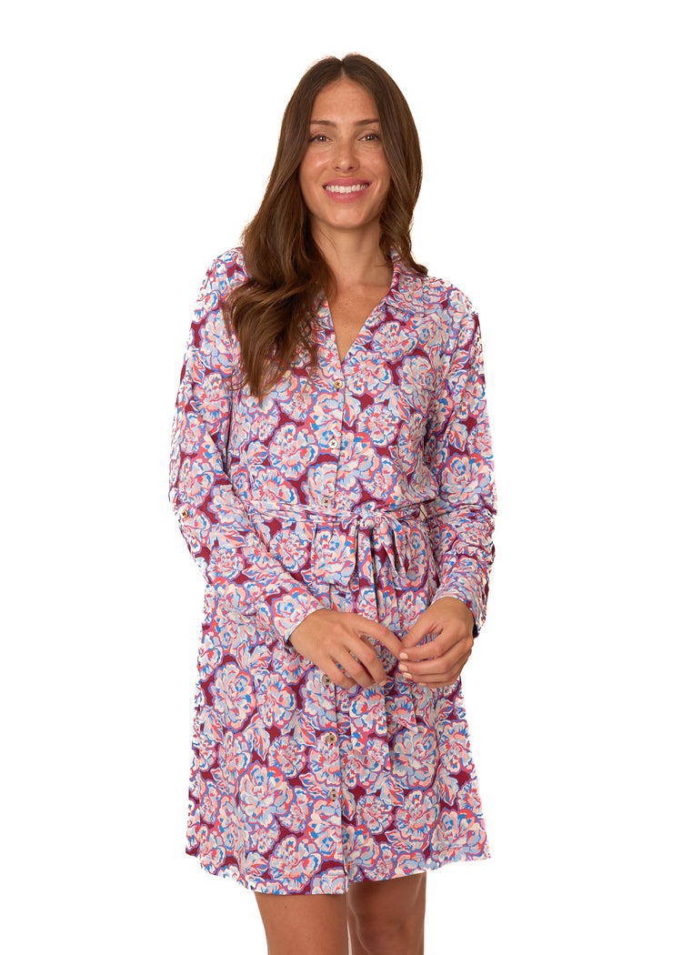 A brunette woman wearing Cabana Life's sun protective Camden Peony Button Down Shirt Dress on a white background.