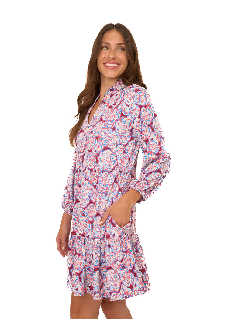 The side of a brunette woman wearing Cabana Life's sun protective Camden Peony Relaxed Dress with her hand in her pocket on a white background.
