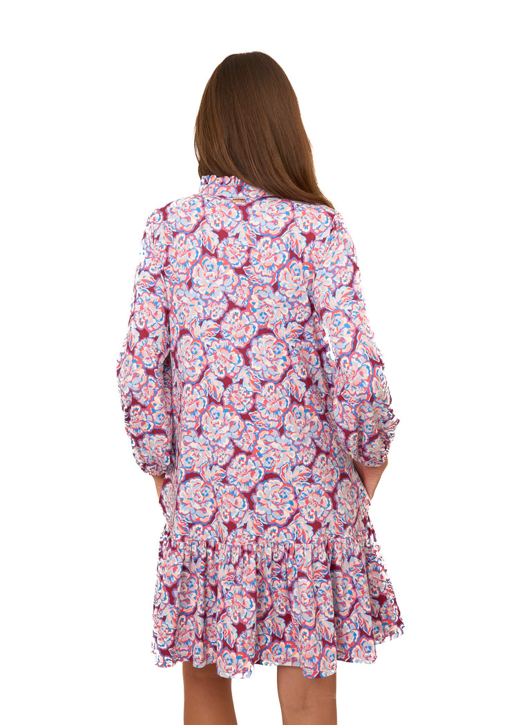 The back of a brunette woman wearing Cabana Life's sun protective Camden Peony Relaxed Dress on a white background.