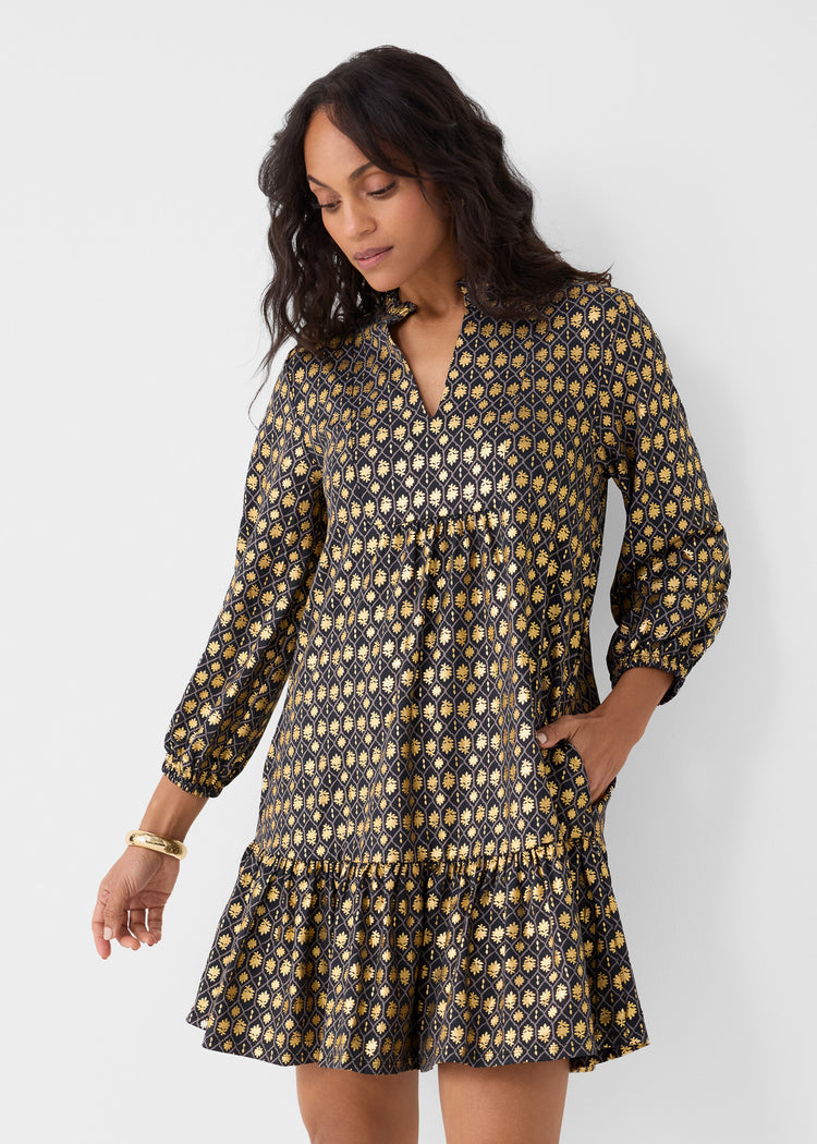 Woman wearing a patterned dress against a white background