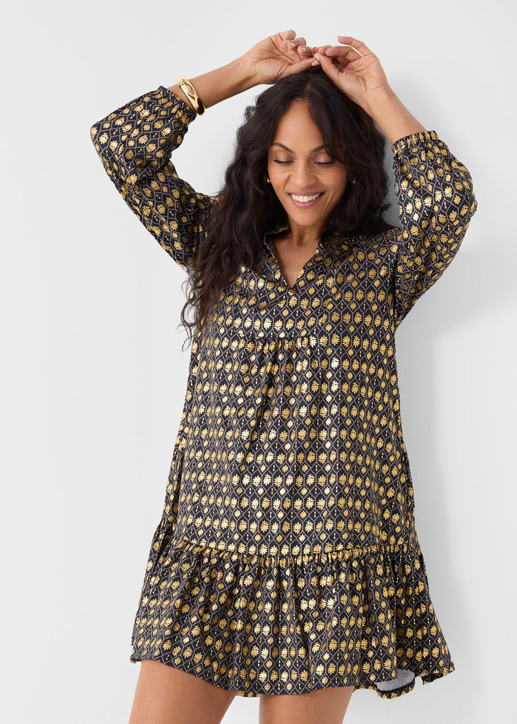 Woman wearing a patterned dress against a white background