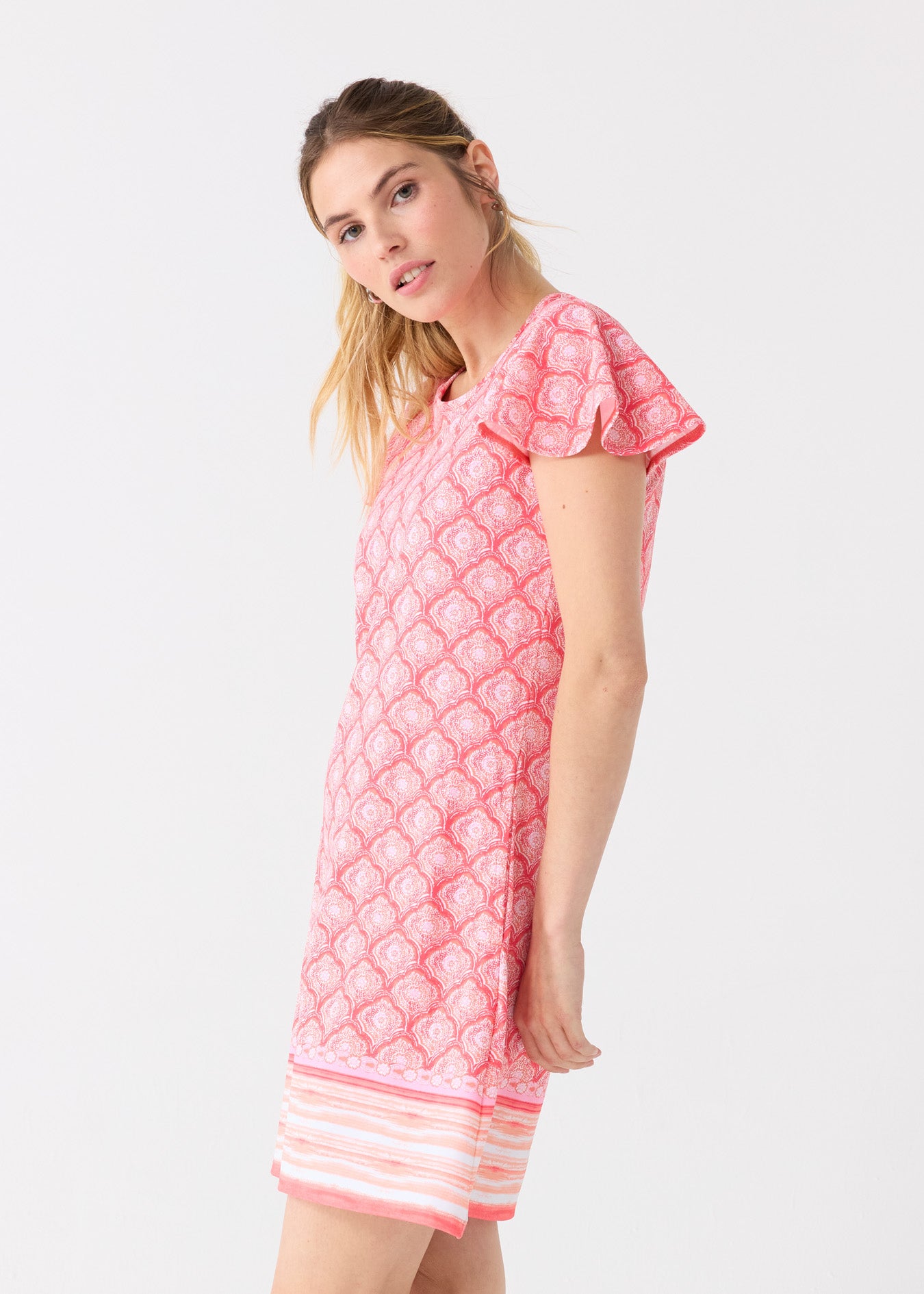 The side of a blonde woman wearing the Cabana Life sun protective Amelia Island Ruffle Short Sleeve Dress.
