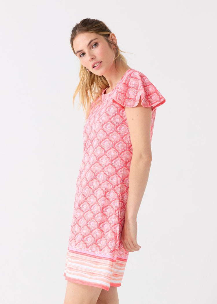 The side of a blonde woman wearing the Cabana Life sun protective Amelia Island Ruffle Short Sleeve Dress.
