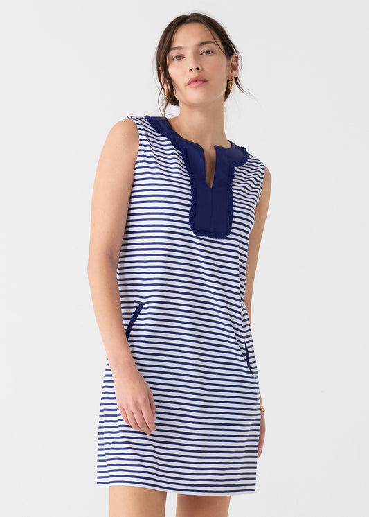 A dark haired woman wearing the Cabana Life sun protective Navy Stripe Sleeveless Fringe Tunic Dress.