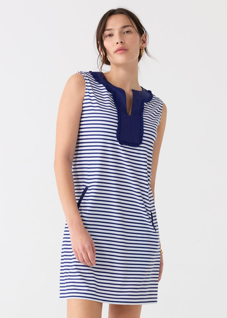 A dark haired woman wearing the Cabana Life sun protective Navy Stripe Sleeveless Fringe Tunic Dress.
