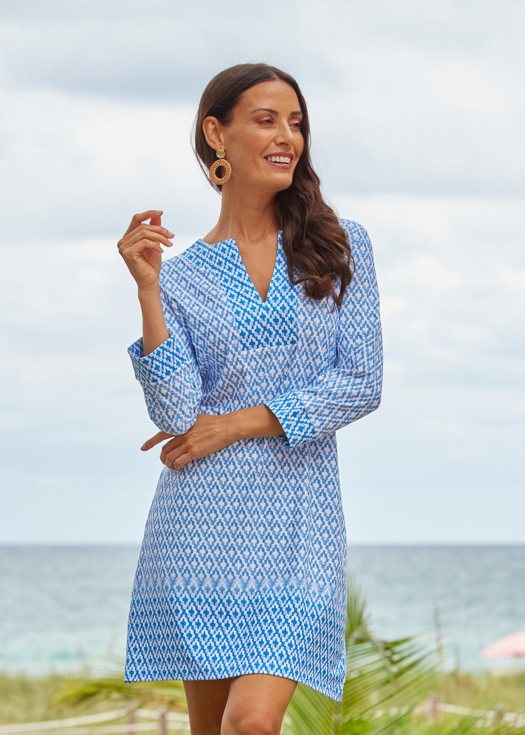 Brunette woman wearing our UPF 50+ Seaside Tunic Dress standing on a beach.