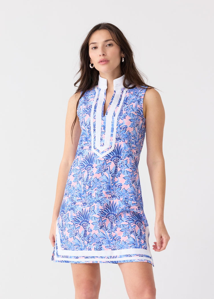 A brunette woman wearing the Cabana Life sun protective Palm Beach Sleeveless Tunic Dress at a studio.