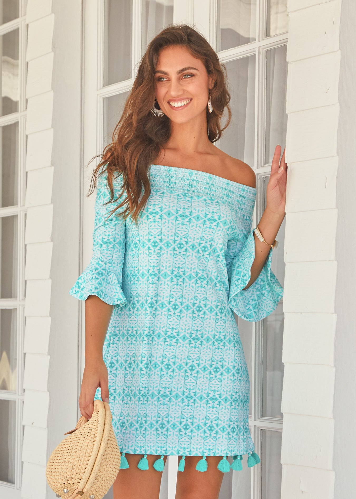 Woman wearing Sunshine Shores Off The Shoulder Dress holding purse