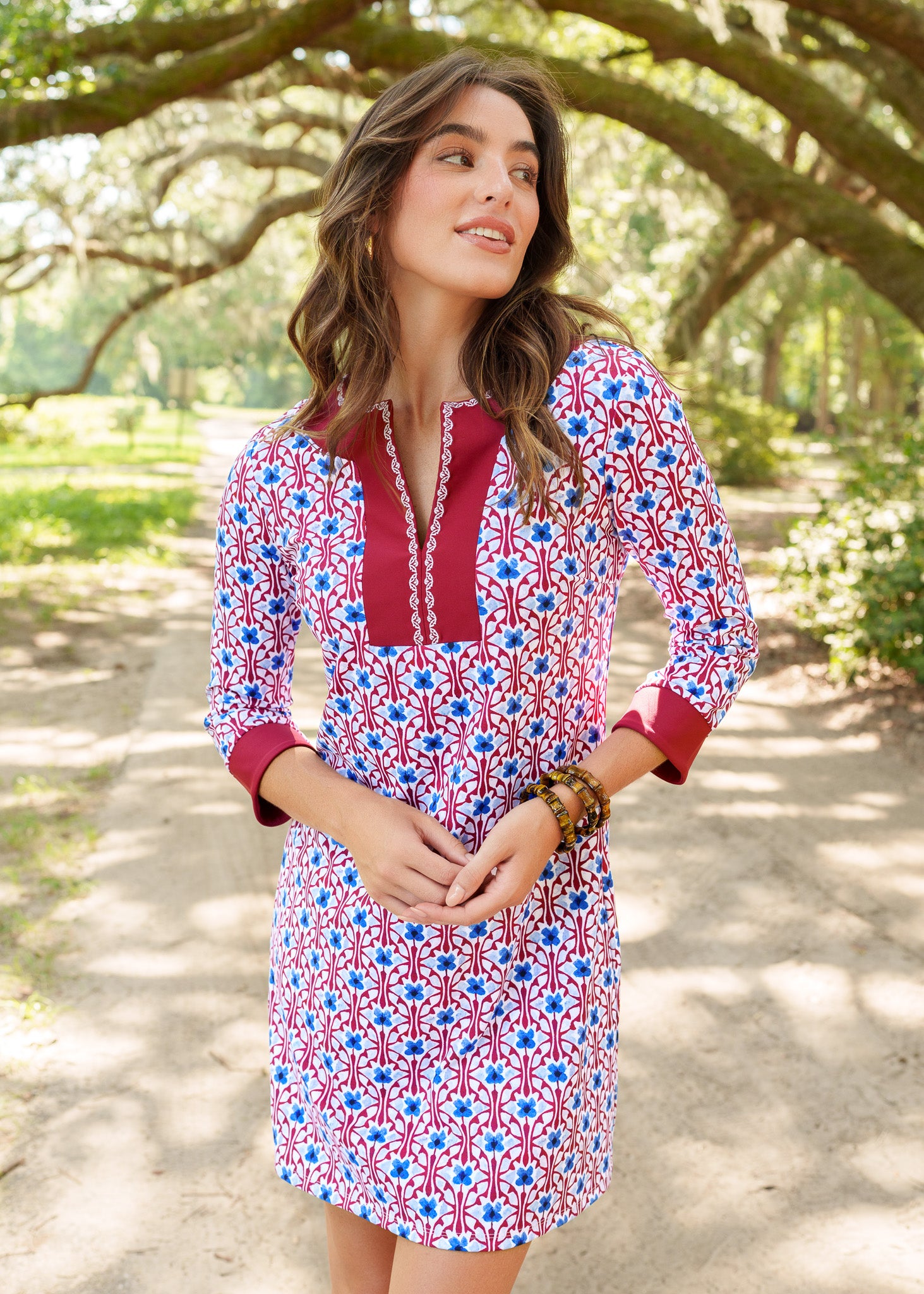 Woman wearing a patterned dress standing in a park