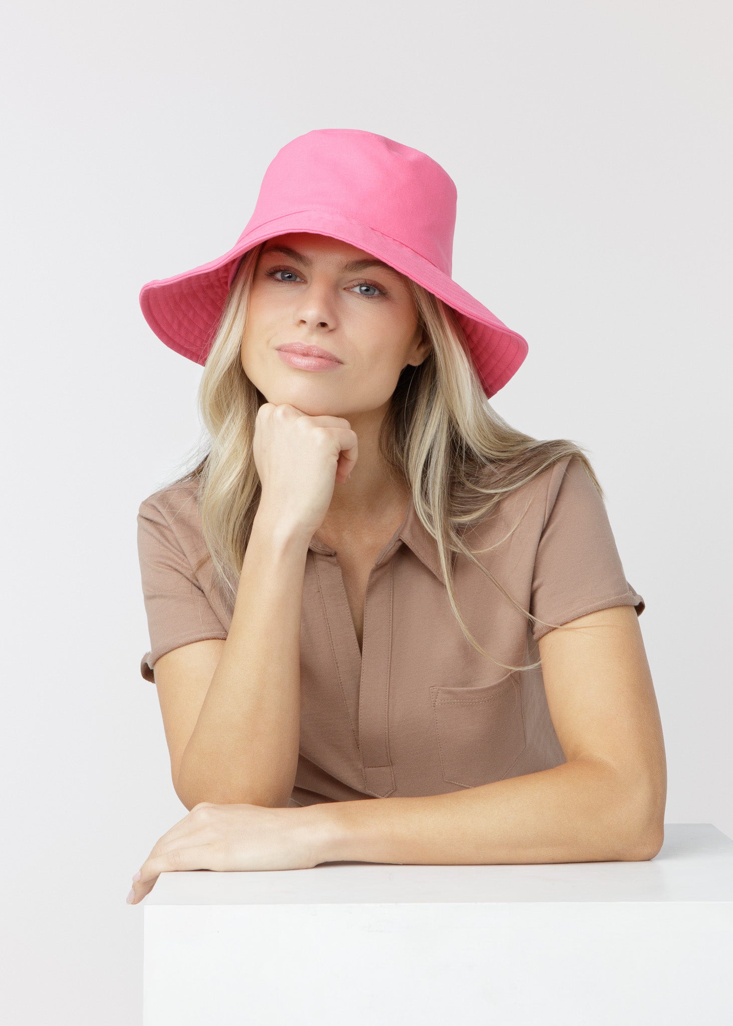 Blonde woman wearing our UPF 50+ Magenta Bucket Hat.