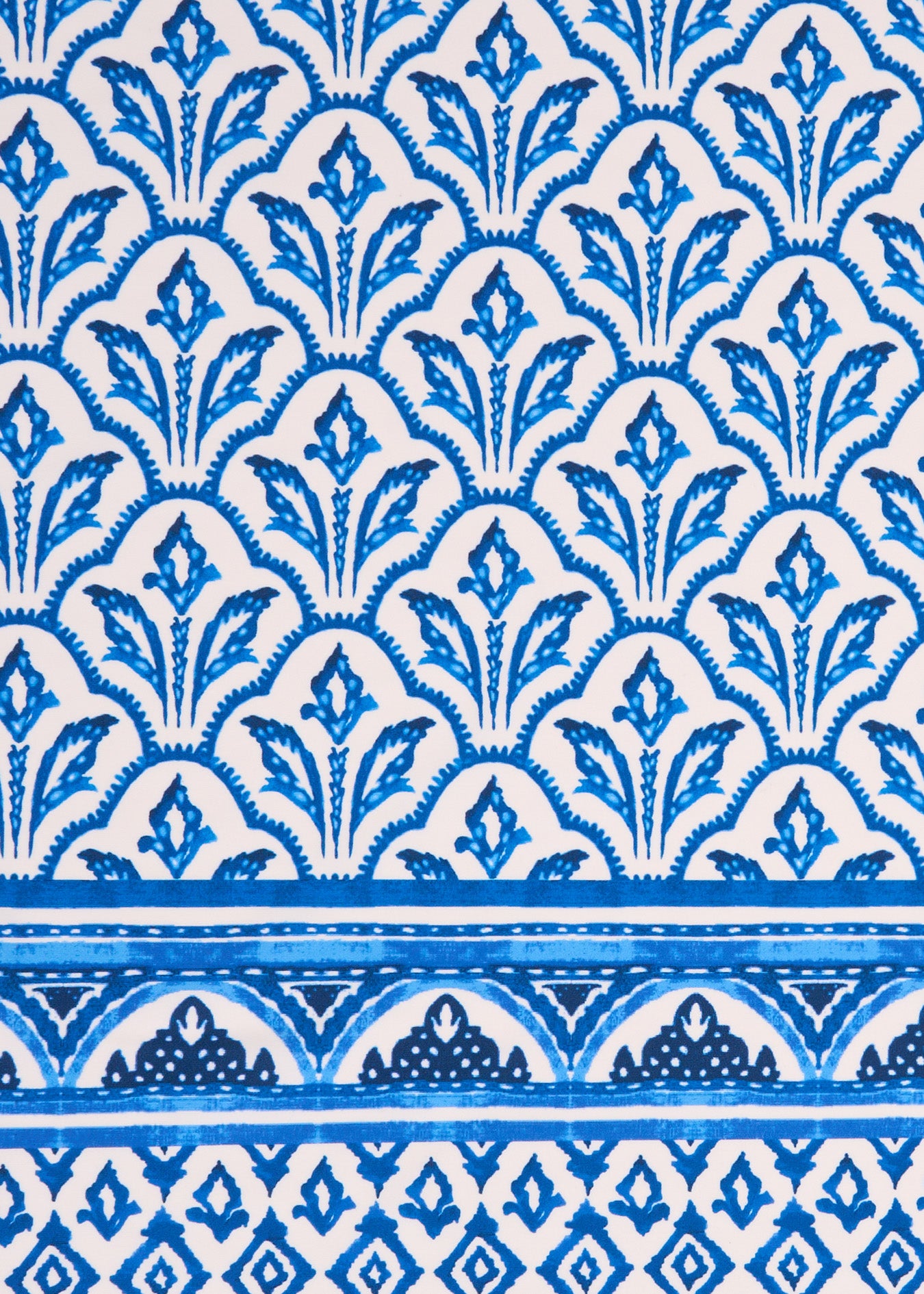 A close up of the blue and white printed Cabana Life sun protective fabric on the Blue Game Day dresses.