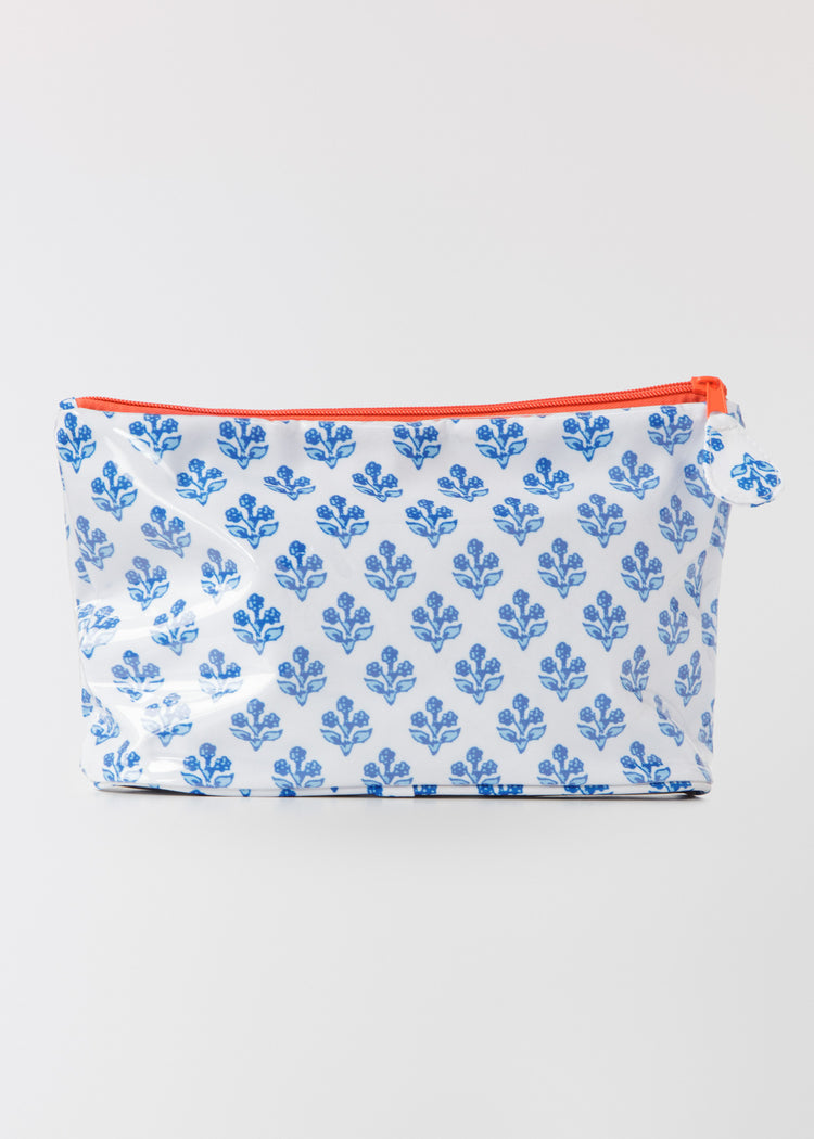 Small accessory bag with blue floral pattern and orange zipper on a white background