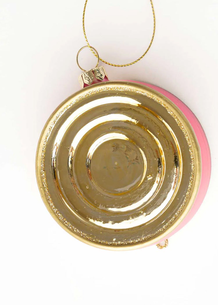 Gold ornament with pink interior on a white background