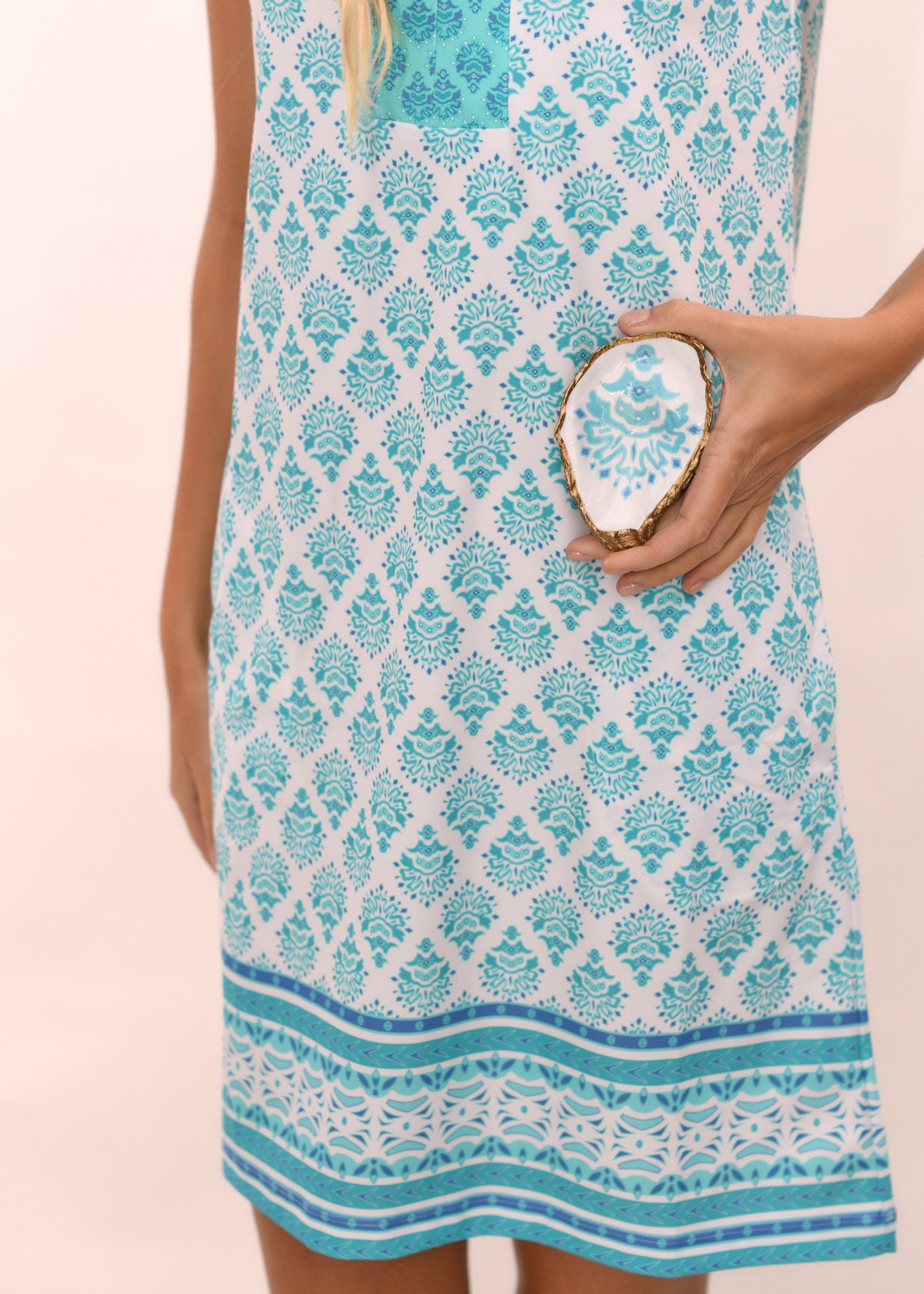 Woman wearing Amalfi Coast Sleeveless Tunic Dress holding Amalfi Coast Oyster Jewelry Dish