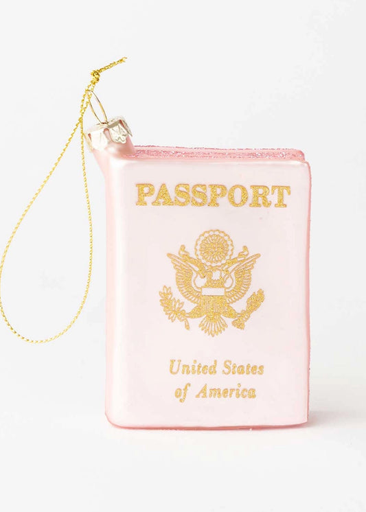 Pink passport ornament with gold text and design on a white background