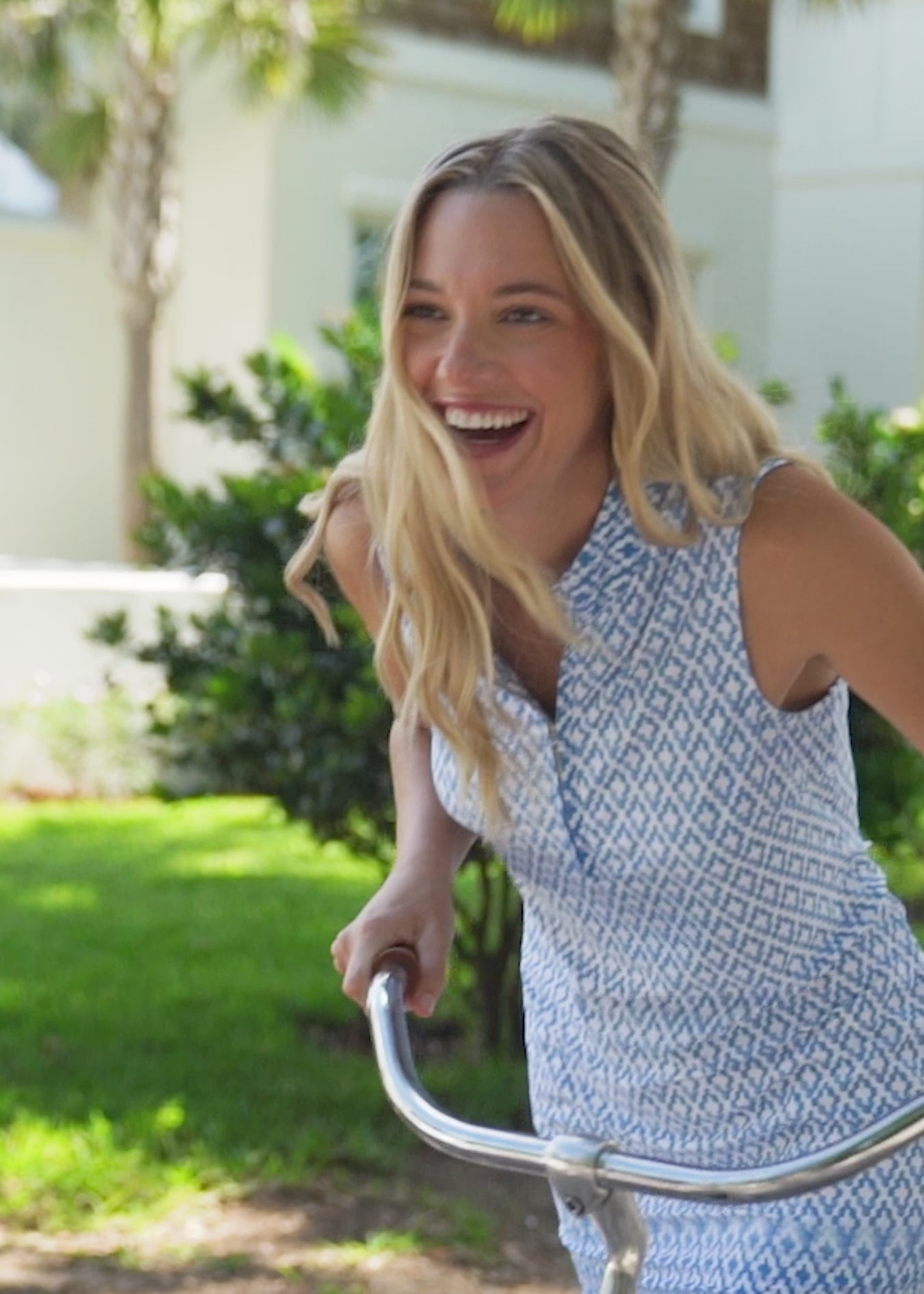 A blonde woman walking outside wearing the Cabana Life sun protective Seaside 1/4 Zip Sleeveless Sport Dress.