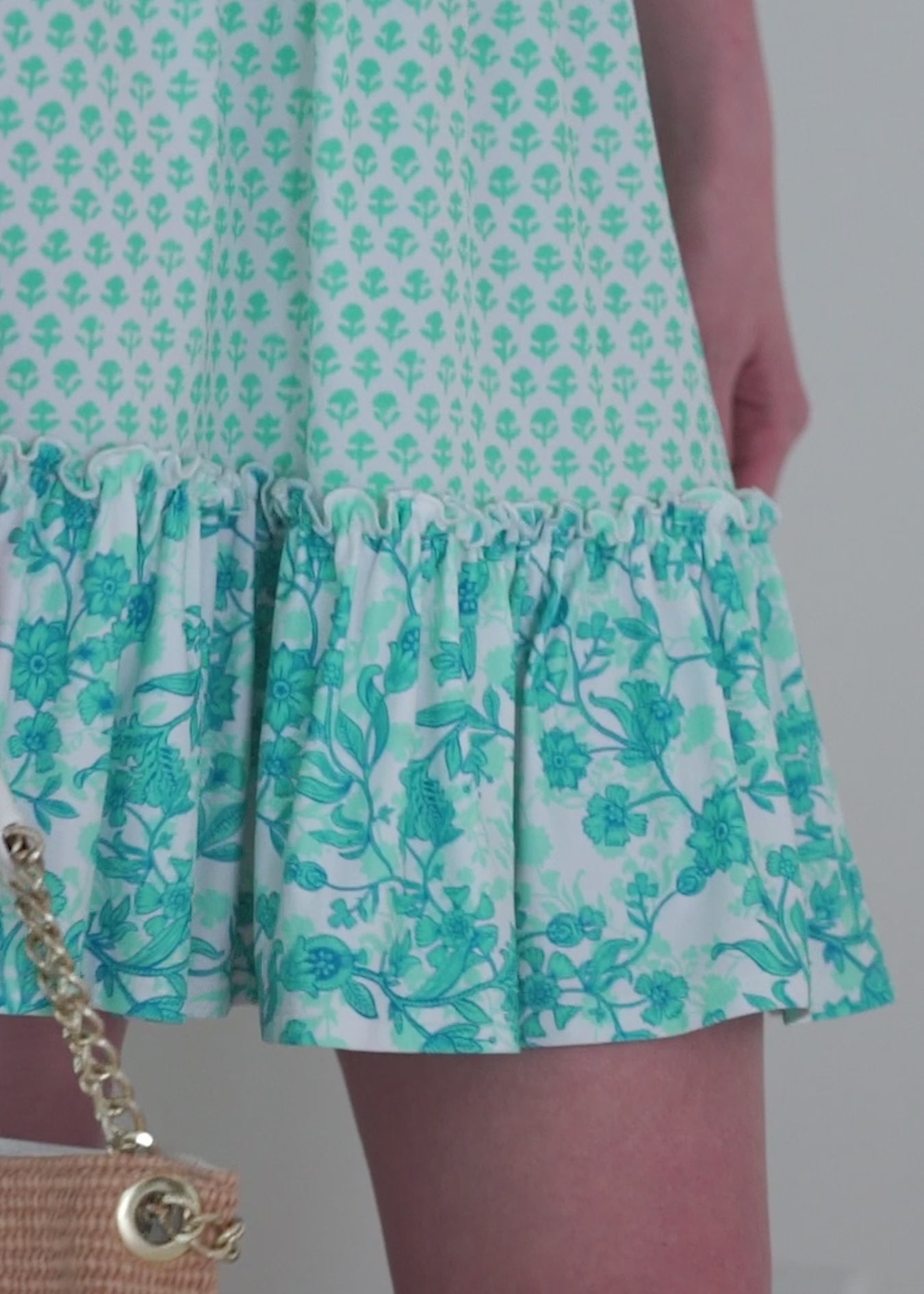 A redhead woman wearing the Cabana Life sun safe Rosebay Smocked Waist Dress inside.