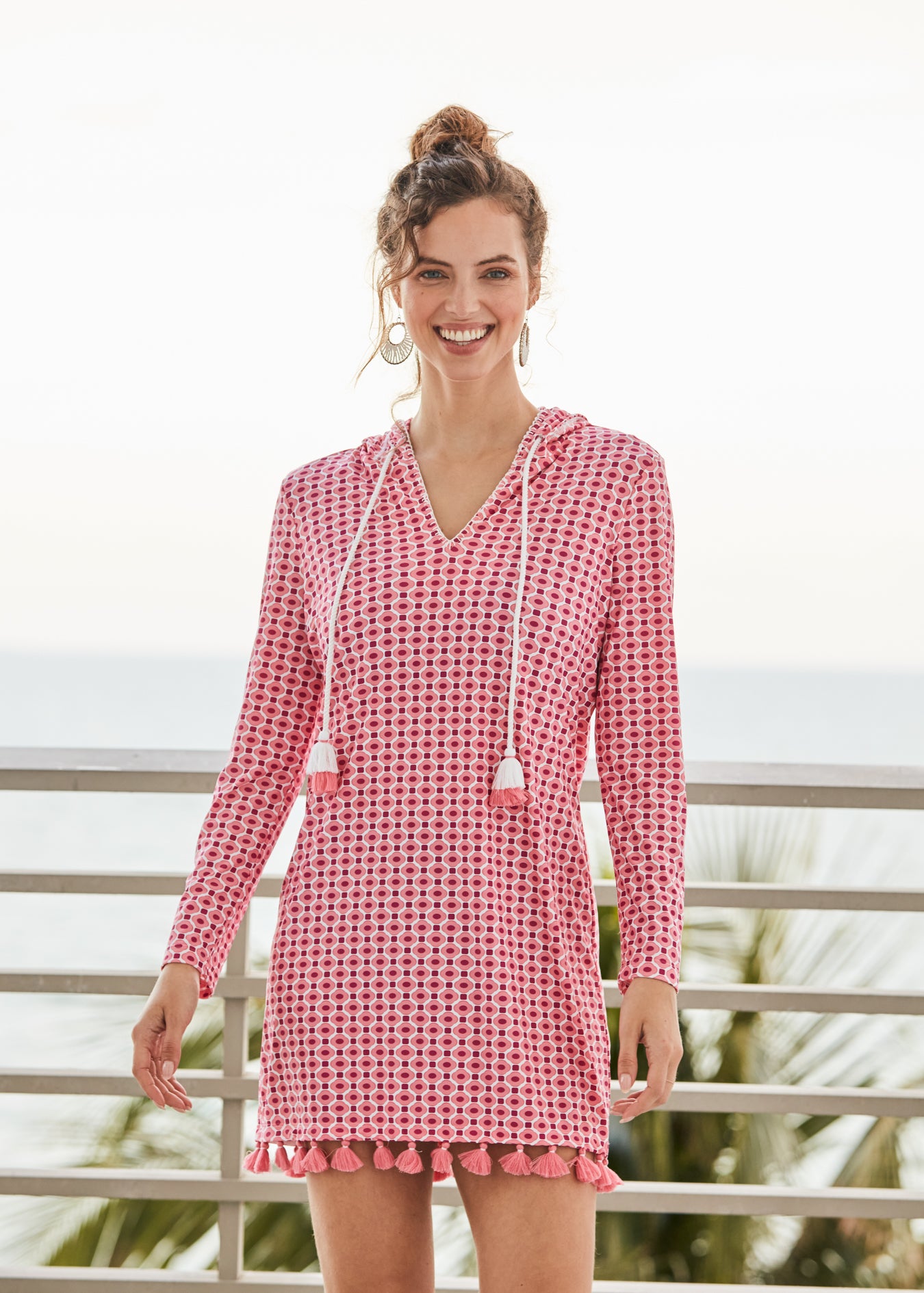 Woman wearing Coral Gables Hooded Cover Up overlooking ocean.
