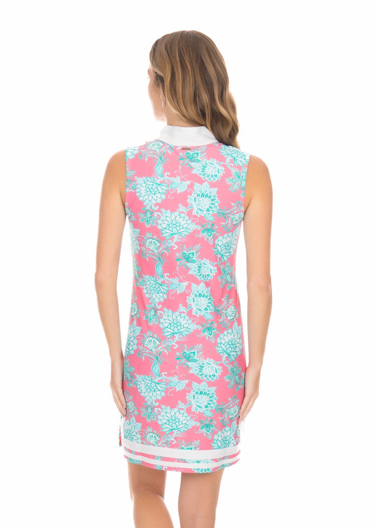 A blonde woman facing backward in front of a white background wearing the Cote D`Azur Sleeveless Tunic Dress.