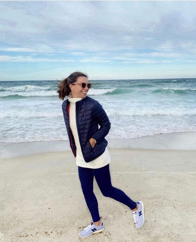 Woman on beach wearing Cabana Life Midnight Navy Swim Leggings