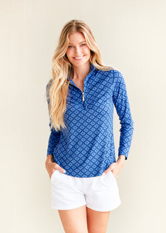 Woman wearing Fisher Island Navy Sport Zip Polo with White Microfiber Short.