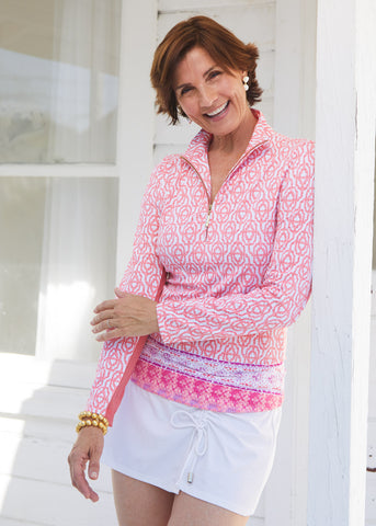 Woman wearing Napa Sport Zip Polo and white side tie swim skirt