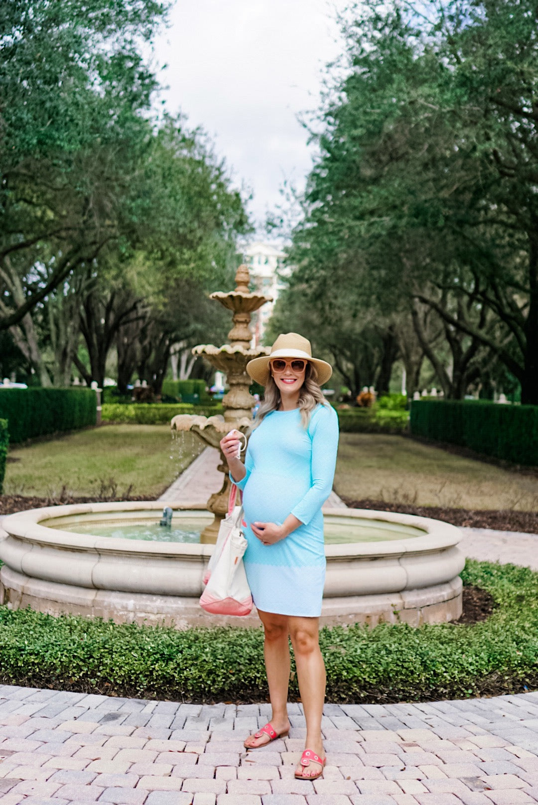 Woman in front of fountain wearing Cabana Life Coral Tides Mint Cabana Shift Dress