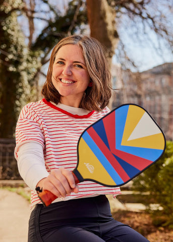 Nettie founder Catherine holding a pickleball paddle
