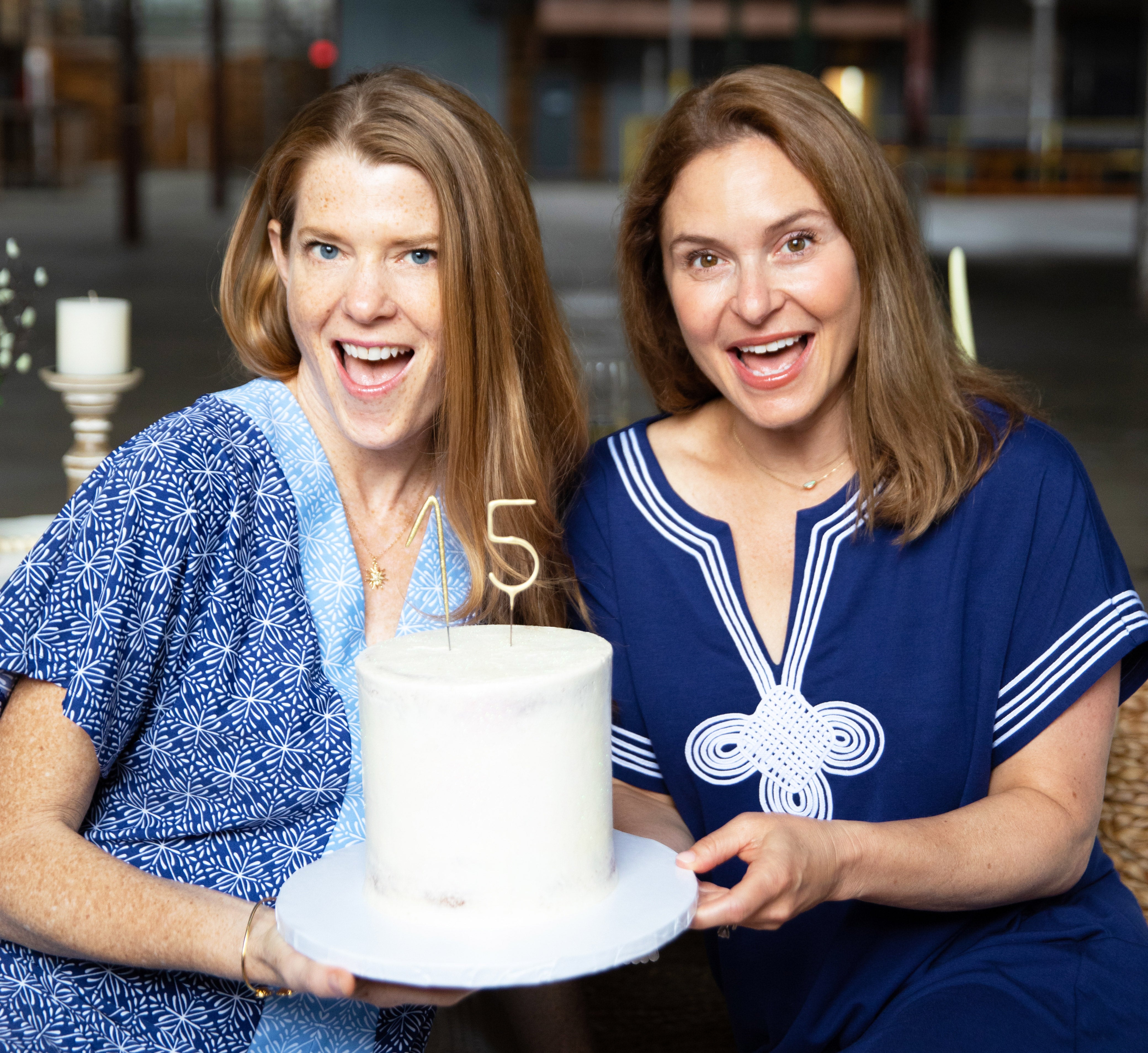 Cabana Life Founders wearing West Indies Maxi Dress and Navy Tee Dress with cake
