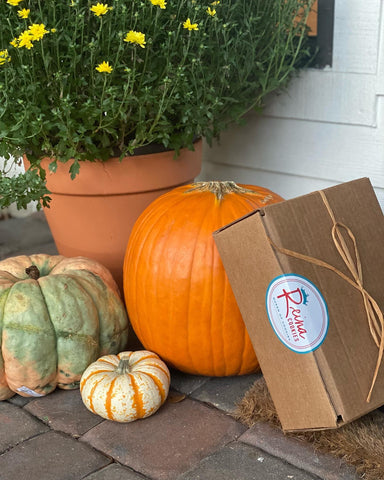 box and pumpkins in front of door