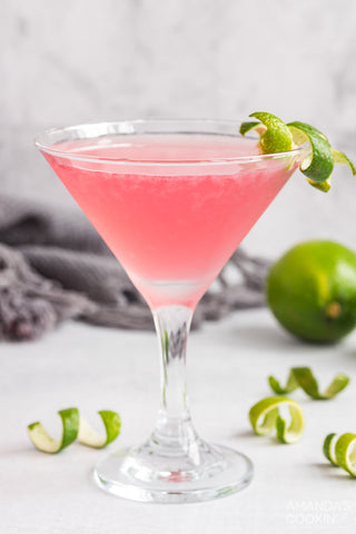 Cosmopolitan in glass with lime peel twist