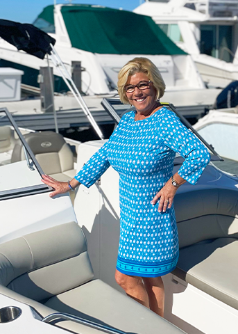 Woman wearing Palm Valley Cabana Shift Dress on boat in marina