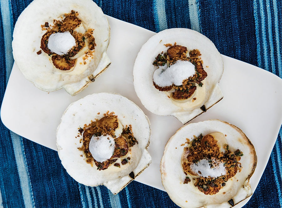 Nantucket Baked Scallops in large white scallop shells on blue table cloth