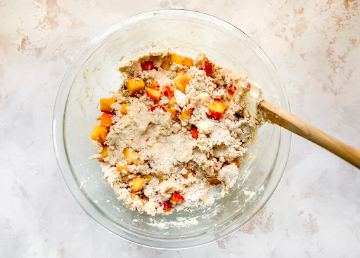 peach scone mixture in bowl with spatula